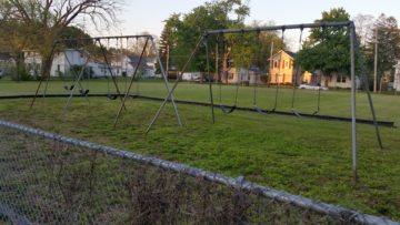 Swingsets and open space by closed South Main Elementary.