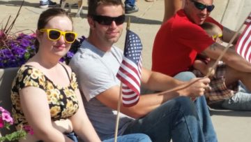 Becky Wittkofski and Jared Baker watch parade downtown.