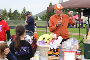 Jerry Anderson begins auction of gift baskets.
