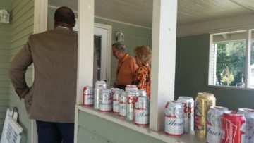 Beer cans line porch where mayor and BGSU leaders visited.