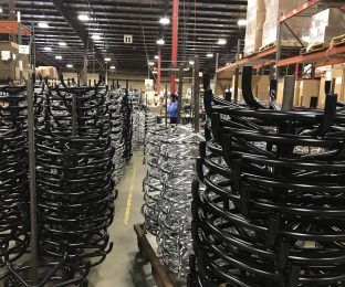 stacked chair bases inside manufacturing plant