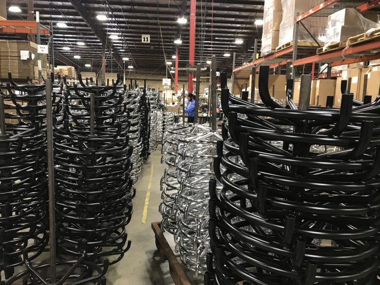 stacked chair bases inside manufacturing plant