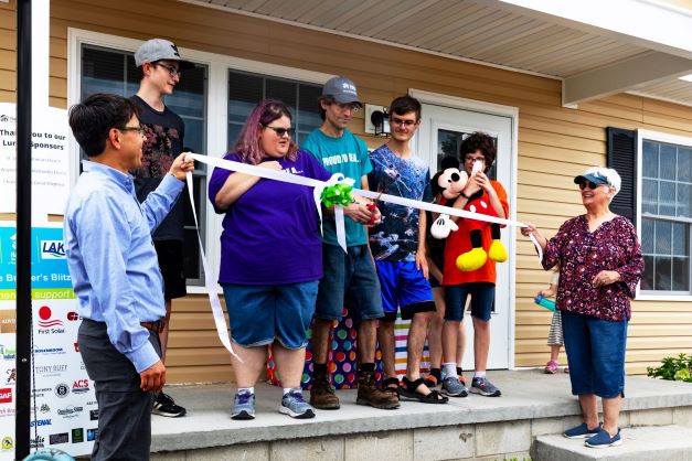 Pearce family cuts ribbon on their new home.

