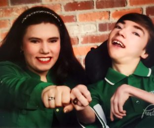 woman and man wear green shirts to promote cerebral palsy awareness