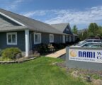 Gray office building with white trim. NAMI sign on right.