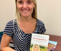 Woman holds book titled "An Unimaginable Act"