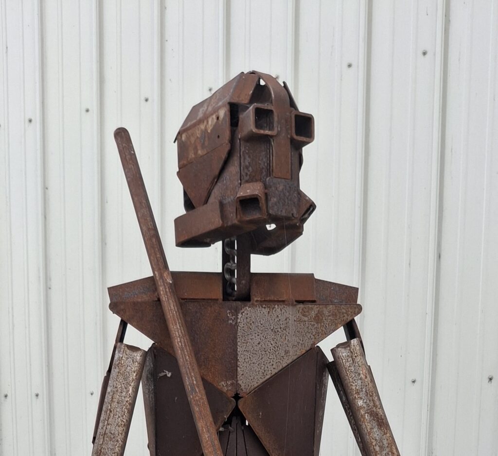 Close-up of metal "Proto-man" sculpture by Daniel Leck.