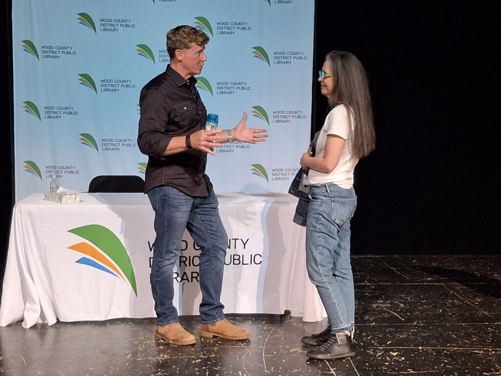 Kevin O'Connor talking to a community member.