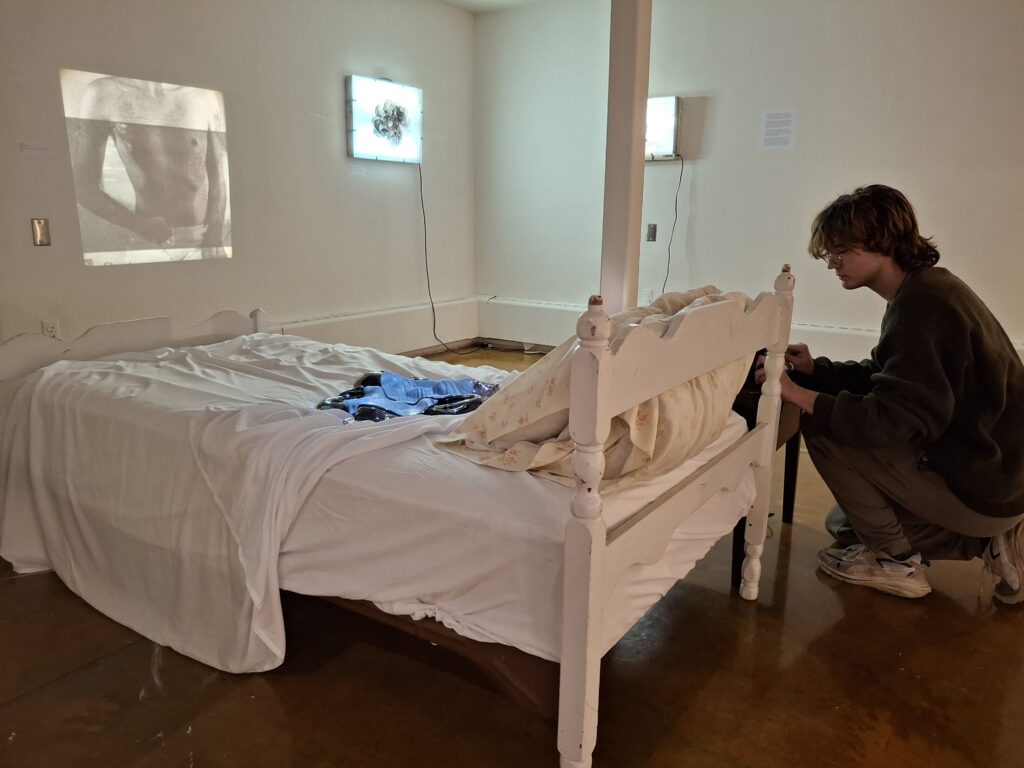 Nick Zisko adjusts a slide projector as part of his exhibitions