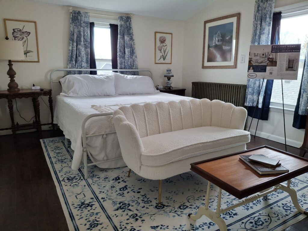 A white bedroom with a settee.