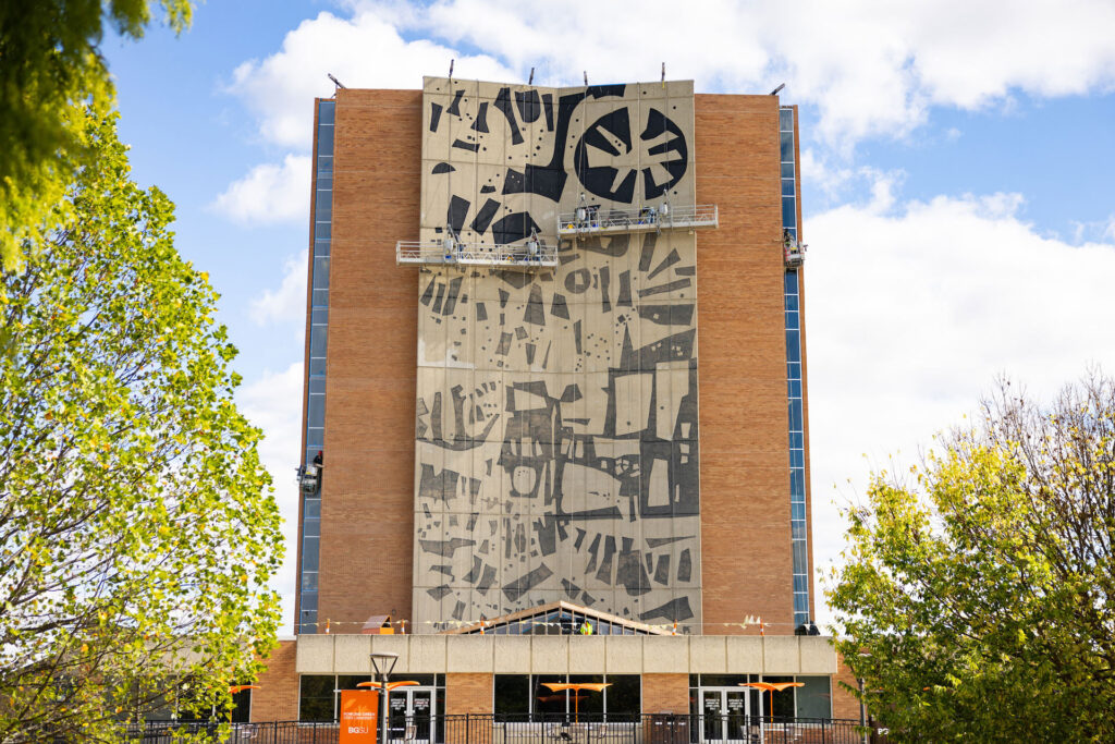 Workers restoring a mural.