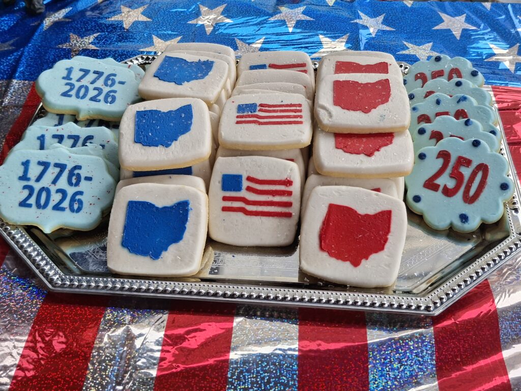 A plate of red, white and blue iced cookies