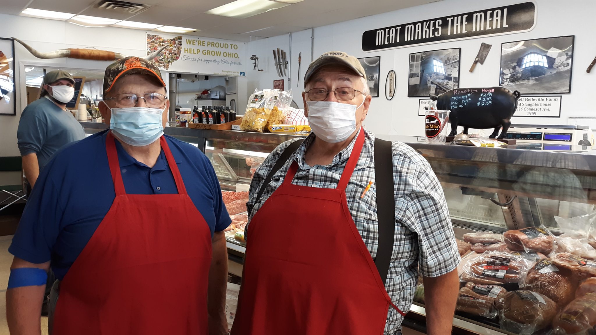 Bellevilles serve the public behind meat market counter and behind the 