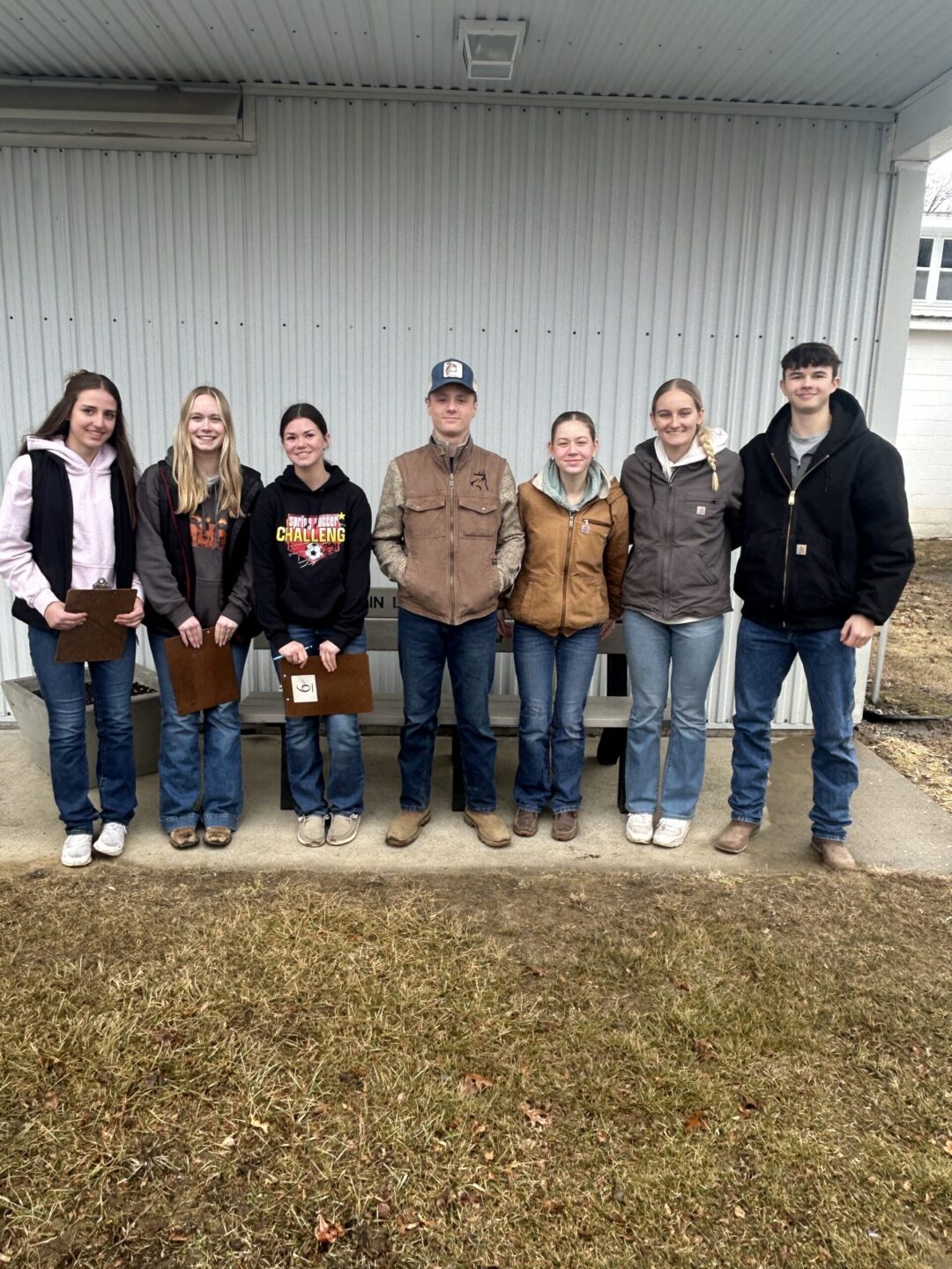 Seven FFA members stand in a row, smiling