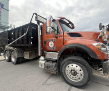 Picture shows a public works truck parked downtown