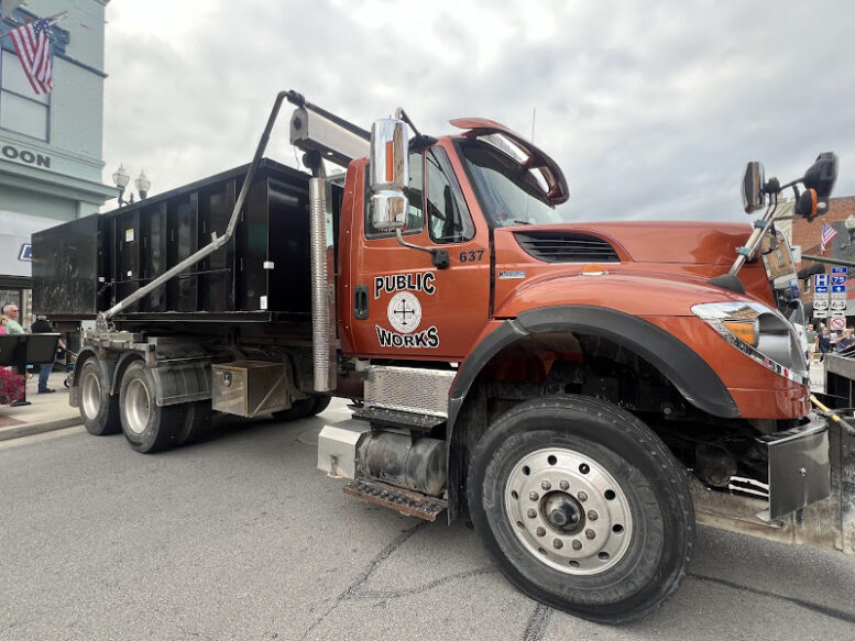 Picture shows a public works truck parked downtown