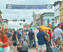 Picture of people attending a festival in the middle of a downtown street