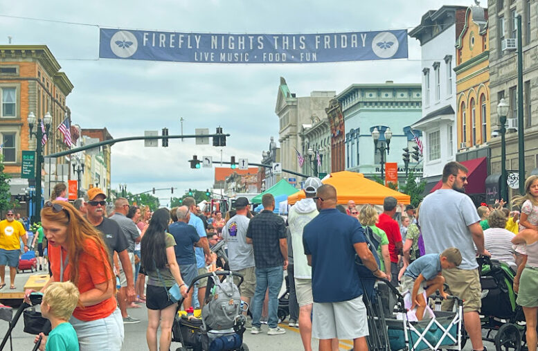 Picture of people attending a festival in the middle of a downtown street