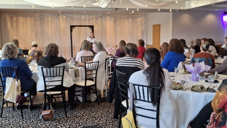Audience members at the Women in Business luncheon listen to Jessica Miller-Blakely speak.