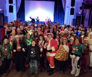 Group photo of event-goers in holiday costumes