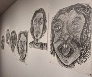 Large graphite drawings of faces