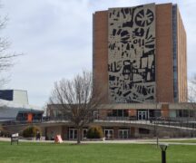 Abstract black and white mural on the side of a building.