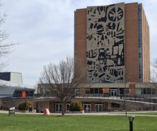 Abstract black and white mural on the side of a building.