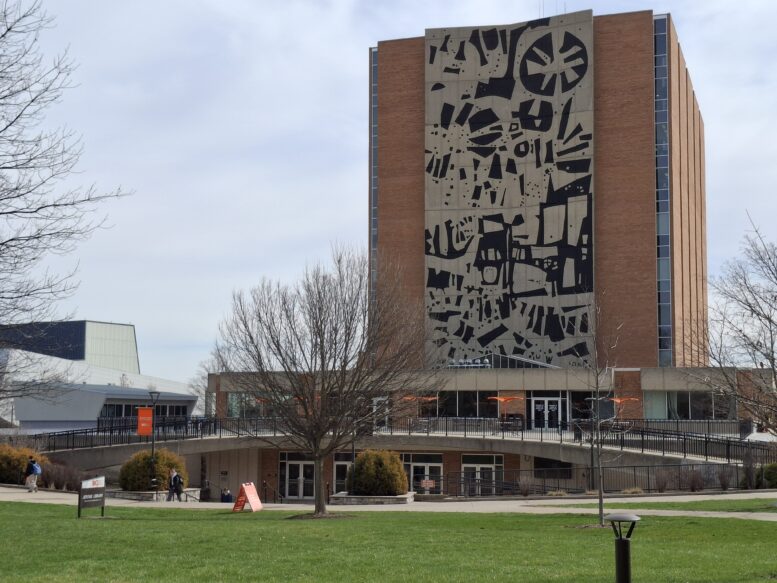 Abstract black and white mural on the side of a building.